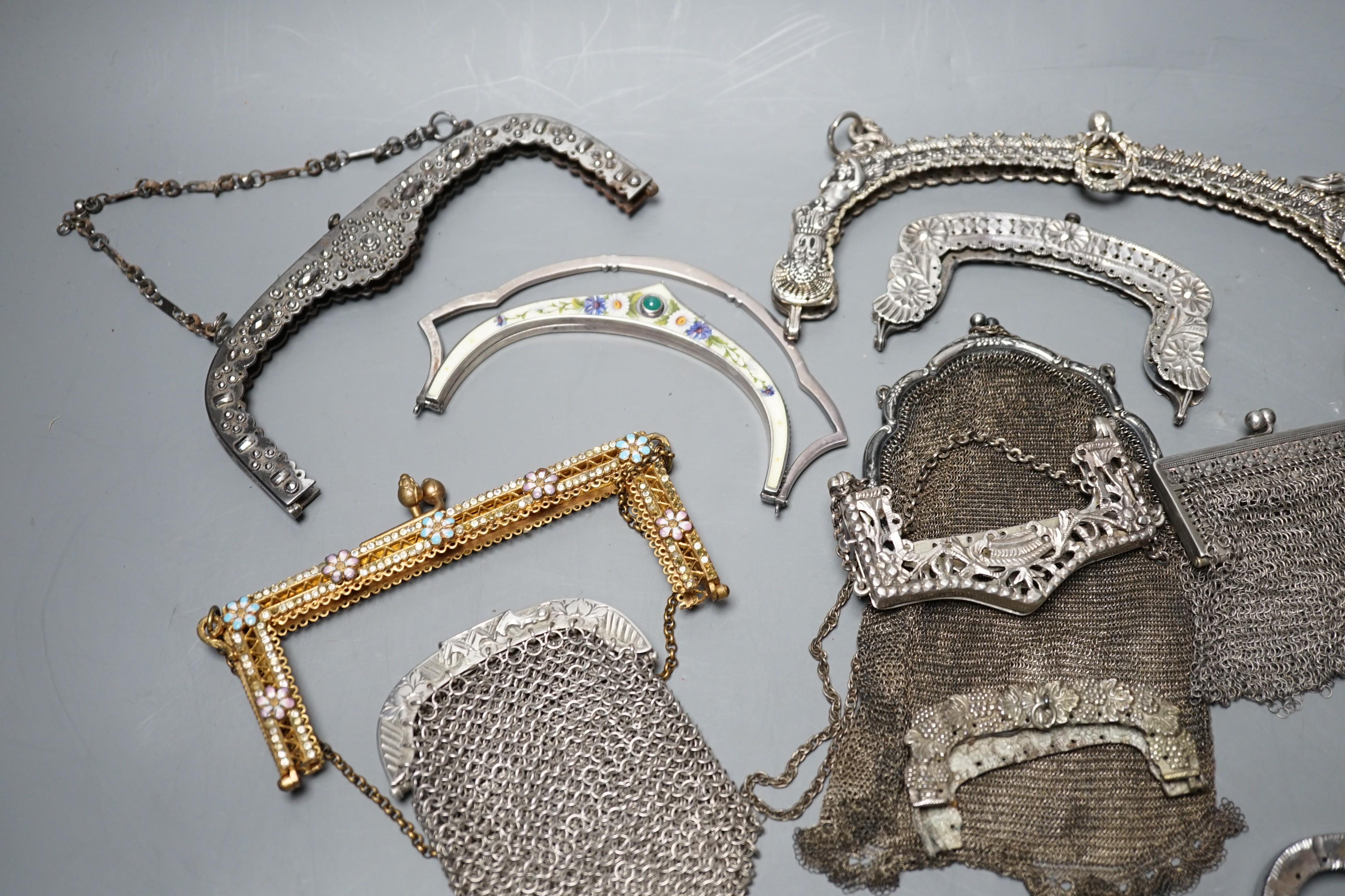 A silver enamel handbag frame, a gilt metal diamanté and enamel frame, eight mixed metal frames, a chain mail bag and three purses, late 19th early 20th century